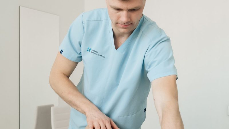 A clinician assessing a patient's leg and knee mobility